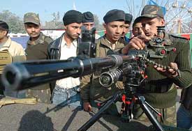 An Army jawan displays a machine gun during Fauji Mela, organised by the Panthers Division to mark Army Day in Amritsar on Saturday