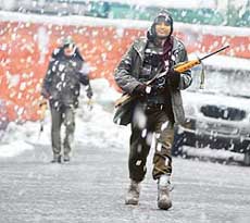 Security force jawans brave the heavy snowfall as they patrol the streets in Srinagar on Tuesday.