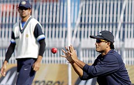 Sourav Ganguly attempts to catch the ball as Rahul Dravid looks on during a practice session at the Iqbal Stadium in Faisalabad on Friday