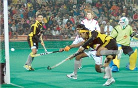 Inderjit Chadha of Chandigarh Dynamos scores a goal against Maratha Warriors during a Premier Hockey League match at the Sector 42 Hockey Stadium in Chandigarh on Saturday
