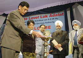 Mr Justice Y.K. Sabharwal, Chief Justice of India, lights a lamp to inaugurate a seminar on Lok Adalats in Amritsar on Sunday.