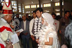 Bishop Alphonse Bilung solemnises the marriage of Indian hockey captain Dilip Tirkey and Meera at the Hamirpur church in Rourkela