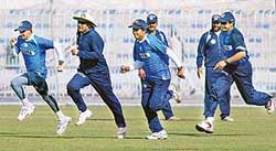 Indian cricketers run during a practice session in Rawalpindi on Friday. 