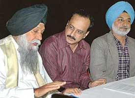 Capt Kanwaljit Singh, a former Finance Minister of Punjab, interacts with Mr Devinder Sharma, chairman of the Forum for Biotechnology and Food Security, during a seminar on �WTO ministerial in Hong Kong and after� at Panjab University in Chandigarh on Saturday