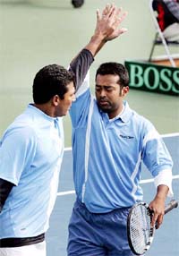 Leander Paes and Mahesh Bhupathi celebrate after winning the doubles tennis match of the Davis Cup Asia Oceania Group I against South Korea's Kwon Oh-hee and Jun Woong-Sun in Changwon