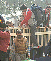 Impatient cricket fans scale the entrance gate of Wagah joint check post to submit their papers for going to Pakistan to see the third one-dayer between India and Pakistan on Sunday.