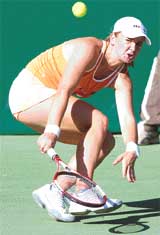 Ukrainian tennis player Mariya Koryttseva returns the ball to her Japanese opponent Akio Nakamura during a first round match of the WTA Bangalore Open in Bangalore on Monday