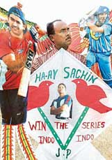 An Indian cricket fan holds specially-designed Chinese kites carrying pictures of Mahendra Singh Dhoni, Yuvraj Singh and Sachin Tendulkar in Amritsar on Wednesday. 