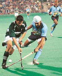 India�s Harpal Singh tries to stop a Pakistani forward during the first encounter of the six-match series at the Sector 42 Hockey Stadium in Chandigarh