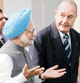 Prime Minister Manmohan Singh gestures as French President Jacques Chirac looks on at Hyderabad House just before a joint press conference in New Delhi on Monday