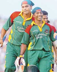 Bangladeshi cricketers Aftab Ahmed (right) and Mashrafe Mortaza leave the ground after the second one-day against Sri Lanka in Bogra on Wednesday. 