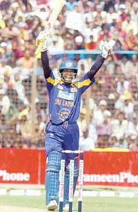 Sri Lanka�s Kumar Sangakkara raises his bat after scoring a century during the third one-dayer against Bangladesh in Chittagong on Saturday. 