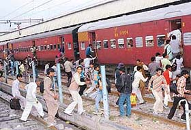Candidates who were in Chandigarh to appear in a test conducted by the Railways rush to board a train at Chandigarh Railway Station