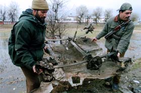 Jammu and Kashmir Police personnel carry the wreckage of a car used in a bomb blast on the outskirts of Srinagar