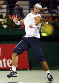 Rafael Nadal of Spain hits a return to Paul-Henri Mathieu of France in the first round of the Dubai Open tournament