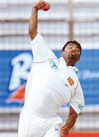 Muttiah Muralitharan in action during the third day of the first Test between Bangladesh and Sri Lanka in Chittagong on Thursday. Murali captured his 1000th Test and ODI wicket. 