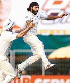 England�s Monty Panesar and Andrew Strauss celebrate the dismissal of India�s Mohammad Kaif on the third day of the first Test in Nagpur on Friday