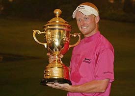 Simon Dyson of the UK holds the trophy after winning the Indonesia Open golf tournament at Emeralda Golf Club in Cimanggis, West Java province, on Sunday