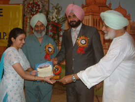 Mr Navjot Singh Sidhu, BJP MP, along with Mr Satyajit Singh Majithia, president, governing council, Khalsa College, Amritsar, awards a girl student at the prize distribution function of the college in Amritsar on Monday