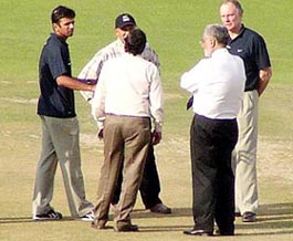 Indian skipper Rahul Dravid and coach Greg Chappell talk to PCA officials after a pitch inspection at the PCA Stadium in Mohali on Monday