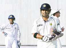 Sachin Tendulkar walks back to the pavilion after being dismissal by England�s Andrew Flintoff as Indian captain Rahul Dravid looks on during the third day of the second Test at the Punjab Cricket Association Stadium in Mohali on Saturday. 