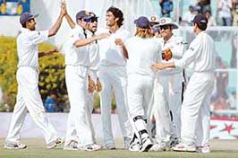 Munaf Patel (centre) celebrates with team-mates after dismissing England�s Alastair Cook on the fourth day of the second Test at the PCA Stadium in Mohali on Sunday.