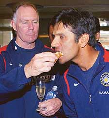 Greg Chappell puts a piece of cake in Rahul Dravid�s mouth to celebrate their victory over England in the Mohali Test