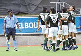 Pakistan players celebrate after scoring a goal as Indian captain Ignace Tirkey looks on during a preliminary hockey match at the Commonwealth Games in Melbourne on Saturday