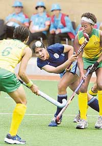 Indian forward Jasjeet Handra flicks the ball past South Africa defender Lenise Marais (left) and midfielder Lesle-Ann George during their women�s hockey match in Melbourne on Saturday