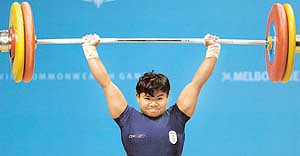 India�s Yumnam Chanu competes in the women�s 58 kg weightlifting competition at the Commonwealth Games in Melbourne on Saturday. The 19-year-old won the gold with a total of 185 kg