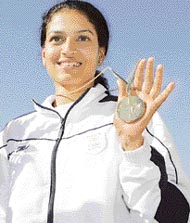 Anuja Jung, wife of Samresh Jung, shows her gold medal after winning the women�s 50m rifle competion at the Commonwealth Games in Melbourne on Thursday