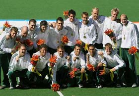 Members of the Australian hockey team pose after receiving their gold medals at the Commonwealth Games in Melbourne