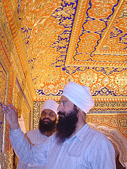 An artist gives finishing touches to the gold plating of the sanctum sanctorum of Darbar Sahib, Tarn Taran, on Wednesday.