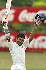 Sri Lankan batsman Kumar Sangakkara celebrates his century during the fourth day of the first Test between Sri Lanka and Pakistan in Colombo on Wednesday