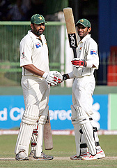 Pakistan�s Shoaib Malik raises his bat on completing a century on the fifth day of the first Test against Sri Lanka in Colombo on Thursday