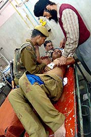 CRPF jawans attend to an injured in hospital after suspected militants blew up a CRPF vehicle in Srinagar on Friday.