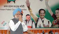 Prime Minister Manmohan Singh greets the media on the final day of the party campaign for the first phase of election to be held on April 3 at Lokpriya Gopinath Bordoloi International Airport in Guwahati on Saturday