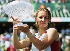 Svetlana Kuznetsova of Russia holds the trophy after defeating Maria Sharapova of Russia in the final of the Nasdaq-100 Open at Crandon Park in Miami, Florida