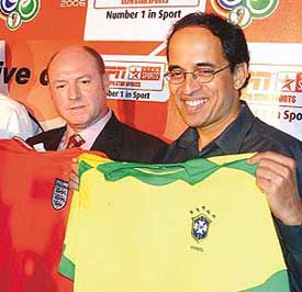 Former England footballer Steve McMahon and ESPN-Star Sports commentator Harsha Bhogle hold the T-shirts of Brazil and England�s football teams during a press conference to announce production and marketing initiatives for the FIFA World Cup in New Delhi on Monday. 