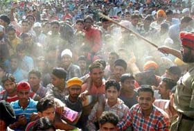 Aspirants in large numbers turn up at an Army recruitment rally as a policeman tries to control the rush in Amritsar