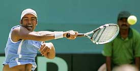 Leander Paes hits a backhand during the Davis Cup doubles match against Pakistan in Mumbai on Saturday. 