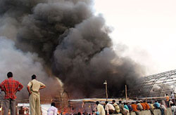 Thick black smoke billows from a tent at a trade fair in Meerut on Monday.