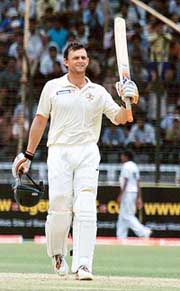 Australian batsman Adam Gilchrist raises his bat after completing his century during the third day of the first Test against Bangladesh in Fatullah on Tuesday. 