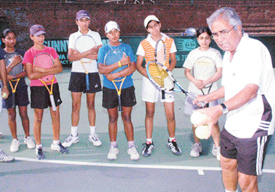 International tennis coach Akhtar Ali teaches the nitty-gritty of the game to budding players at the CLTA complex, Sector 10, Chandigarh, on Friday.