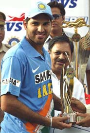 Yuvraj Singh holds the man of the series trophy after India won the seventh one-dayer against England in Indore on Saturday.