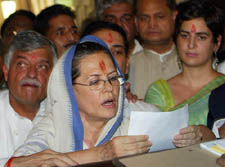 Congress President Sonia Gandhi is watched by her daughter Priyanka