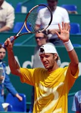 Frenchman Paul-Henri Matthieu waves to the crowds after defeating Russian Marat Safin during their Monte Carlo ATP Masters Series match in Monaco on Tuesday