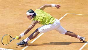 Rafael Nadal of Spain returns the ball to Guillermo Coria of Argentina during the quarterfinal of the Monte Carlo Tennis Open in Monaco on Friday. Nadal won 6-2, 6-1.