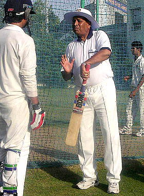 Former Test cricketer Chandu Borde gives tips to a youngster at the PCA Stadium in Mohali on Monday