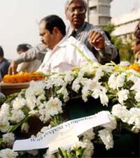Officials with the wreath laid on behalf of Prime Minister Manmohan Singh on the coffin containing the body of Indian engineer K. Suryanarayan at the Indira Gandhi International Airport in New Delhi